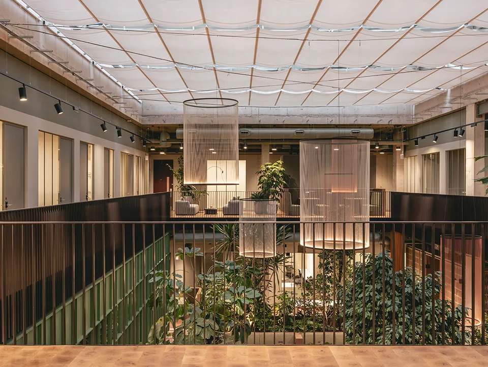 Upper mezzanine level overlooking the plant-filled atrium